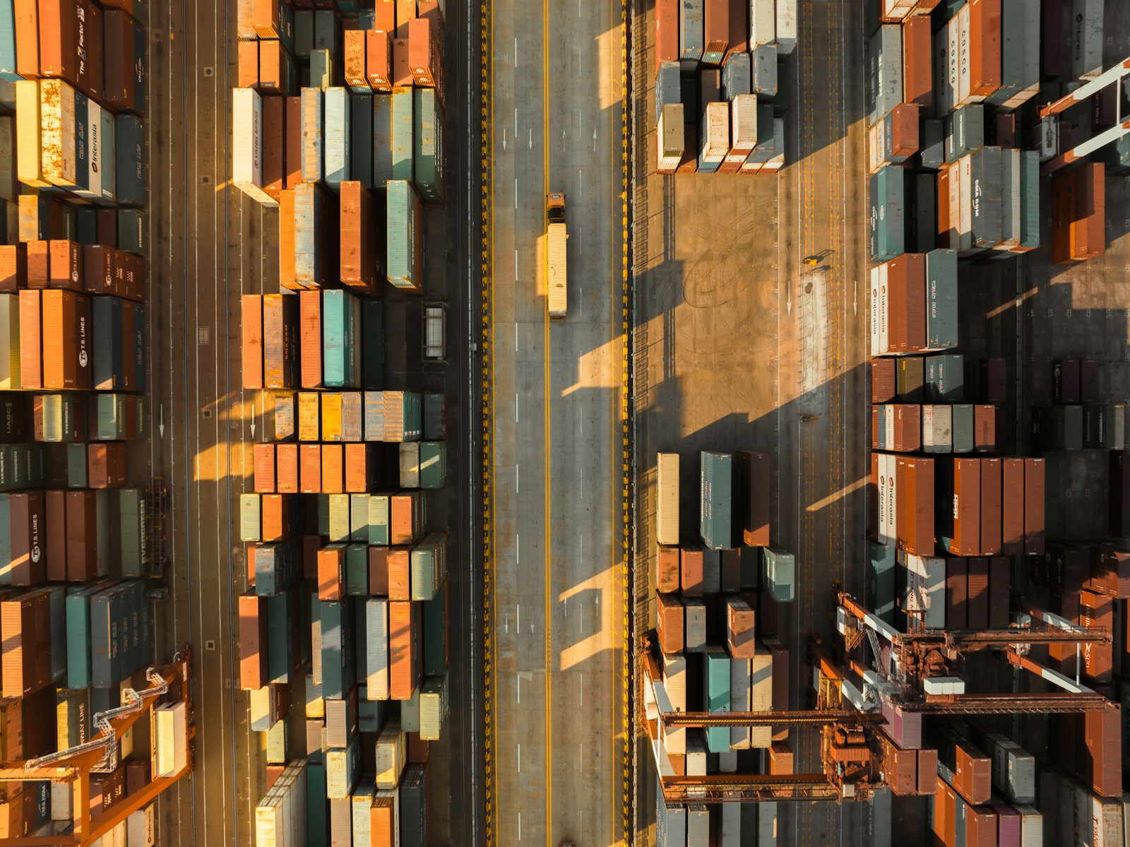 Rows of shipping containers arranged at a coastal port