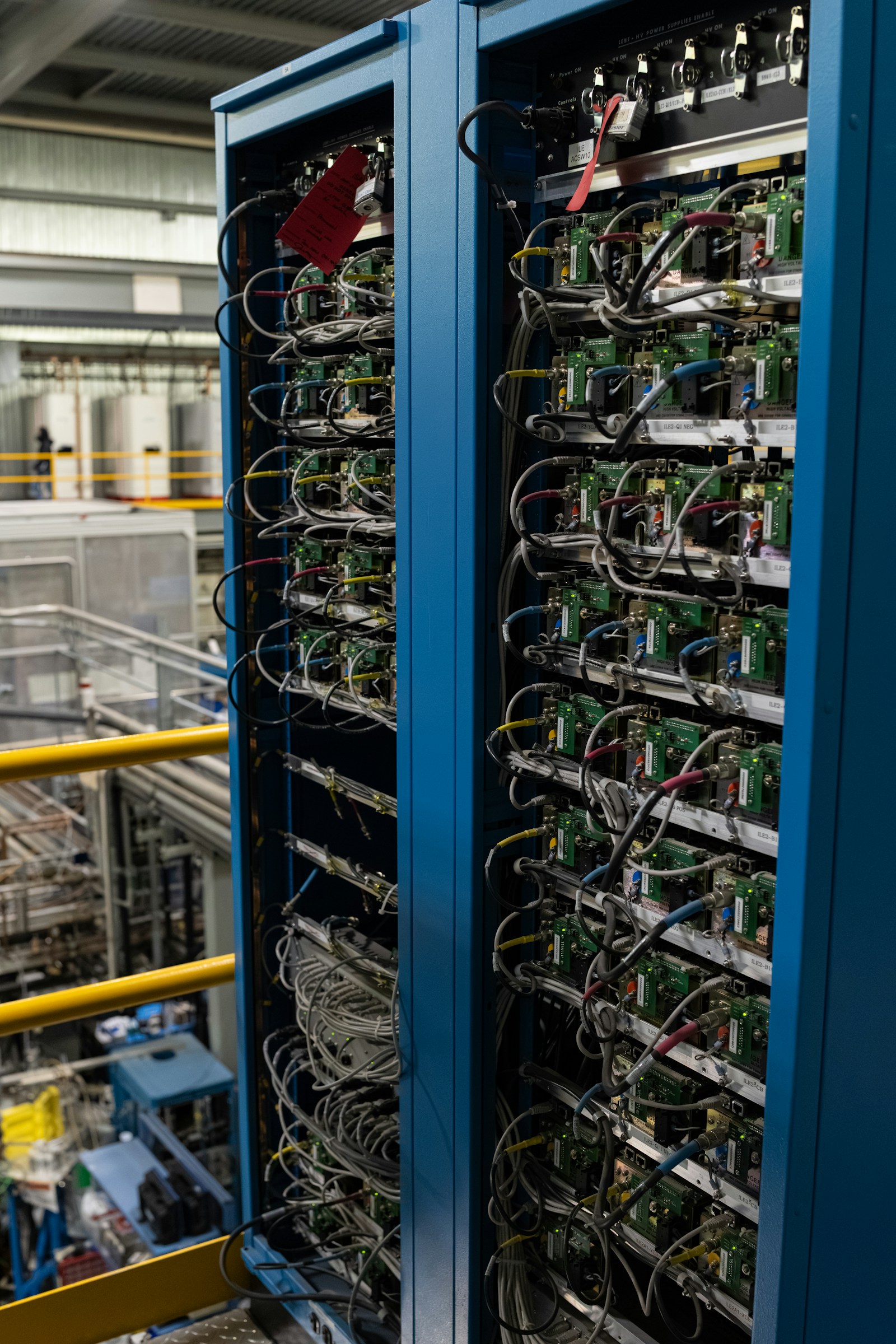 Two equipment racks filled with electronic components and cables