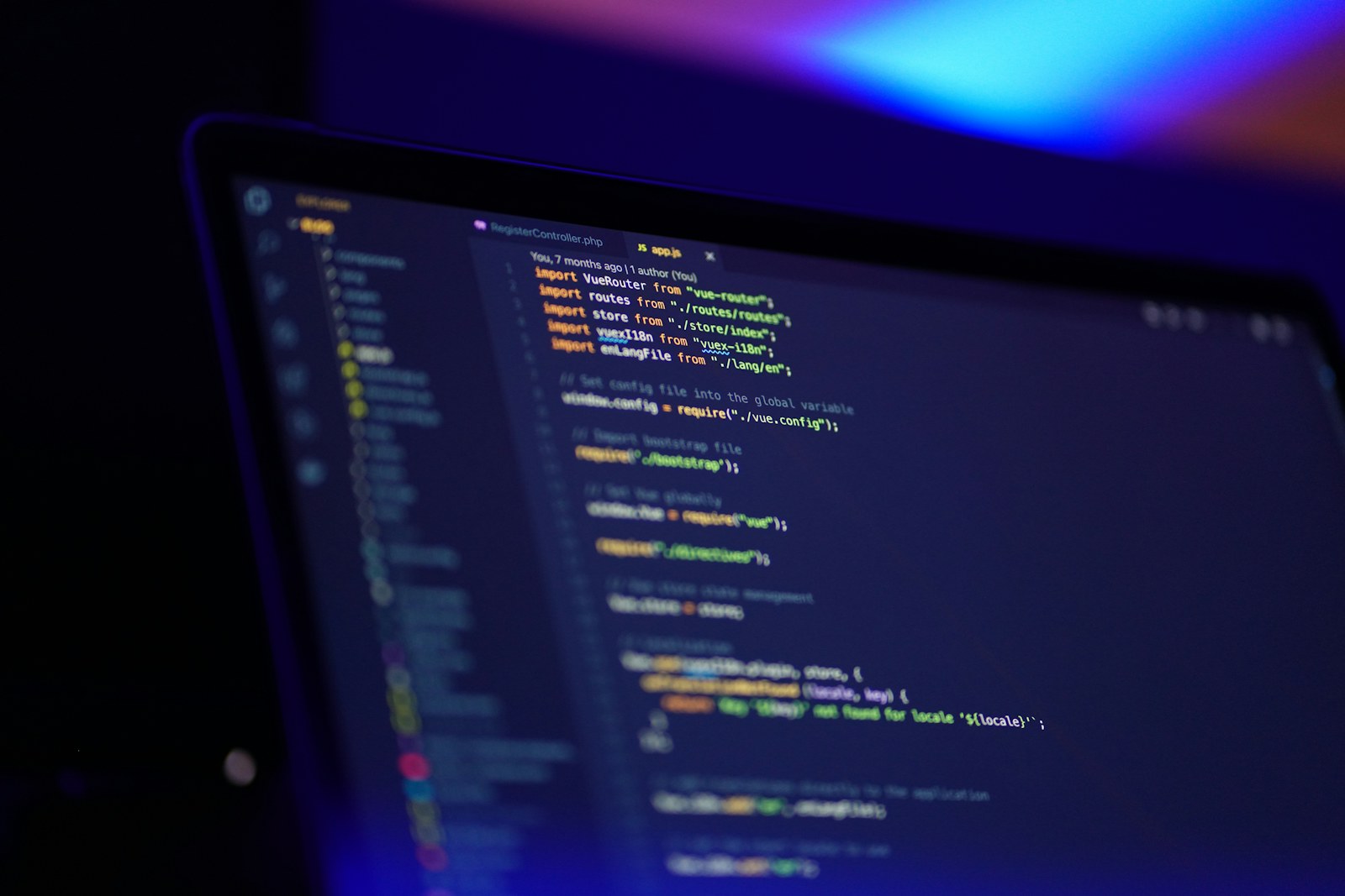 Close-up of a laptop screen displaying colorful source code