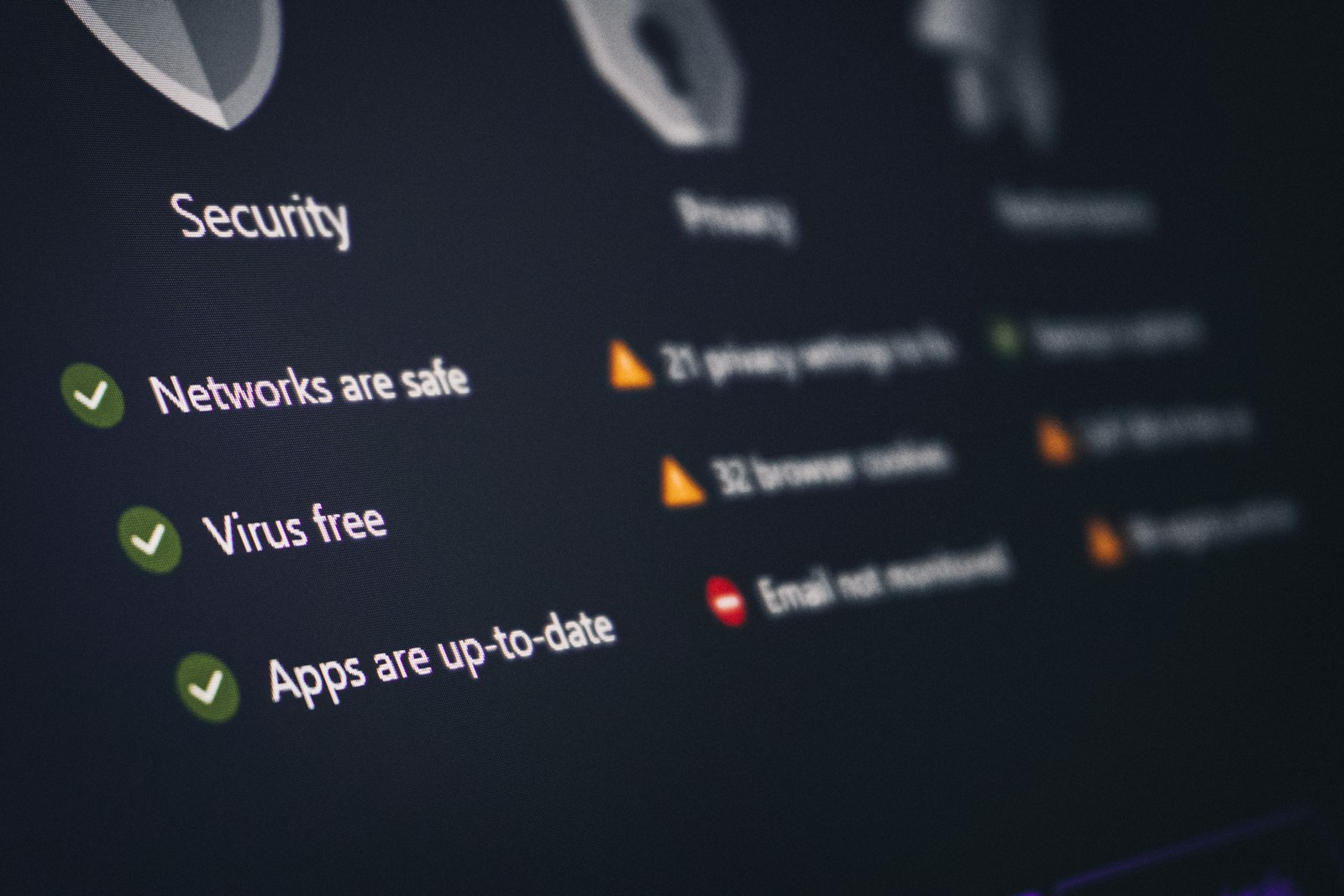 A laptop screen displaying an antivirus security dashboard and status indicators